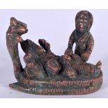 AN INDIAN METAL BUDDHA, modelled with five cobras over his head and attendant at side. 6.5 cm wide.