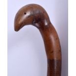 AN UNUSUAL EARLY 19TH CENTURY CARVED WOOD BIRD HEAD WALKING CANE decorated with hearts, motifs and