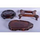 THREE 19TH CENTURY CHINESE CARVED HARDWOOD STANDS in various forms and sizes. Largest 24 cm wide. (