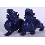 A PAIR OF CHINESE CARVED LAPIS LAZULI MYTHICAL BEASTS, formed with jaws exposed. 19.5 cm wide.