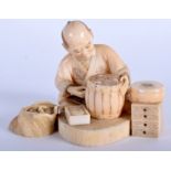 A 19TH CENTURY JAPANESE MEIJI PERIOD CARVED IVORY ARTISAN OKIMONO modelled holding a barrel. 7 cm x