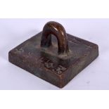 A CHINESE BRONZE SEAL, formed with a high loop handle. 4.8 cm wide.