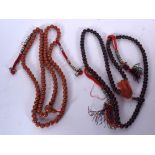 A TIBETAN WOODEN PRAYER BEAD NECKLACE, together with another similar. Largest 76 cm. (2)