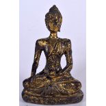 A GILT BRONZE BUDDHA IN THE FORM OF SHAKYAMNUNI, formed seated upon a throne. 9.5 cm high.