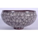 A CHINESE CRACKLE GLAZE POTTERY BOWL, formed upon a tapering foot. 15 cm wide.