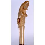 AN UNUSUAL EARLY 20TH CENTURY BLOND RHINOCEROS HORN HANDLED WALKING CANE, the handle in the form of