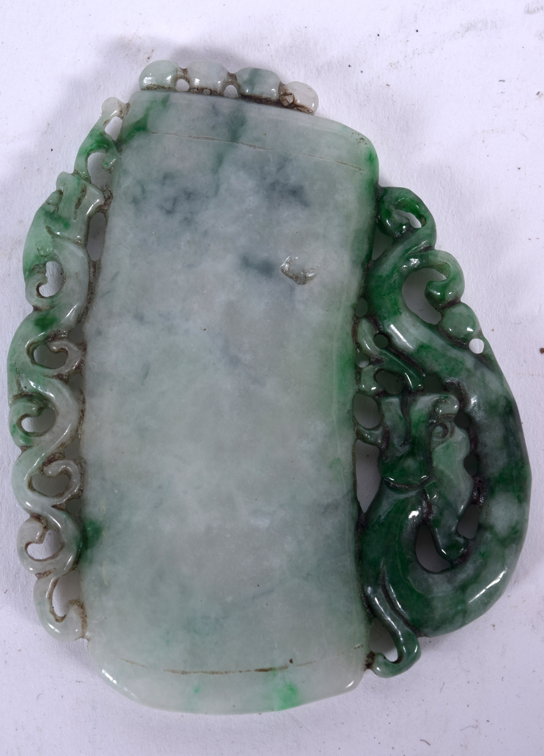 A CHINESE JADEITE CARVING, formed as a plain tablet with chilong clinging to one side. 7.5 cm x 5.7