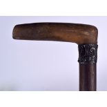 AN EARLY 20TH CENTURY RHINOCEROS HORN HANDLED WALKING STICK, formed with a metal collar. 89.5 cm lo