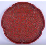 A LARGE 19TH CENTURY CHINESE CARVED RED TIXI LACQUER TRAY decorated with scrolling foliage. 34 cm w