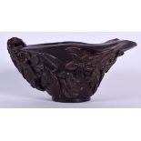 A CHINESE HORN LIBATION CUP, carved with extensive foliage. 15.5 cm wide.