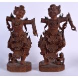 A LARGE PAIR OF EARLY 20TH CENTURY BURMESE CARVED WOODEN FIGURES, carved in elaborate robes. 46.5 c