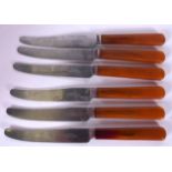 A SET OF SIX AMBER TYPE HANDLED BUTTER KNIVES, “Heal & Son Lt, Tottenham Court Road”. 16.5 cm long.