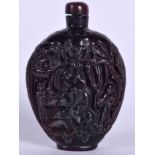 A CHINESE CARVED HORN SNUFF BOTTLE, decorated with figures in a landscape. 10 cm high.