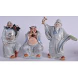 THREE CHINESE PORCELAIN FIGURINES, one formed blowing a brass instrument, together with two others