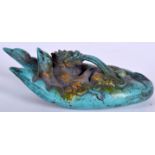 A CHINESE CARVED TURQUOISE SCULPTURE IN THE FORM OF A HAND, formed with a dragon in palm licking a