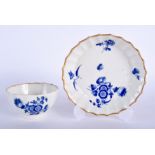 A 18TH CENTURY WORCESTER FACETTED TEA BOWL AND SAUCER painted in dry blue with flowers, fretted squ