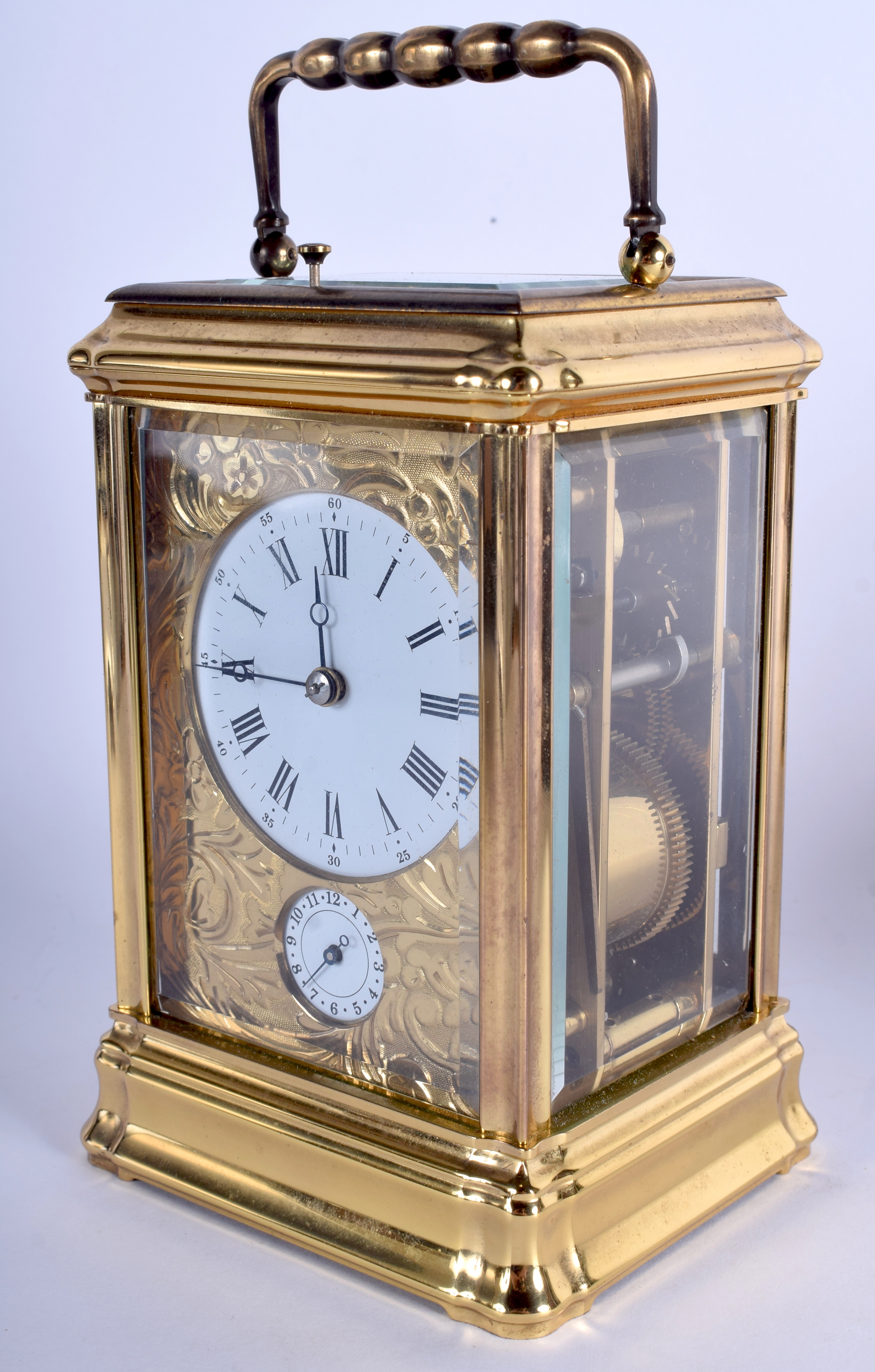 A FRENCH BRASS CARRIAGE CLOCK with engraved brass dial. 17.5 cm high inc handle.