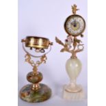 A VINTAGE CLOCK FITTED UPON AN ONYX BASE, together with another similar. Largest 27 cm. (2)