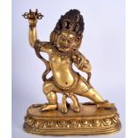 A 19TH CENTURY CHINESE TIBETAN BRONZE FIGURE OF A BUDDHA modelled holding a phurba upon an oval lot
