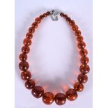 AN AMBER TYPE NECKLACE, formed with bold spherical beads. 50 cm long & weight 101 grams.