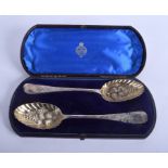 A PAIR OF 18TH/19TH CENTURY EMBOSSED SILVER GILT BERRY SPOONS. 4.2 oz. 21 cm long.
