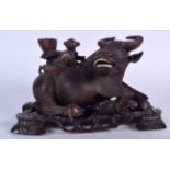 A LARGE LATE 19TH CENTURY CHINESE CARVED HARDWOOD BUFFALO ON STAND, formed with a rider upon its ba
