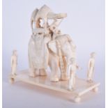 A 19TH CENTURY INDIAN CARVED IVORY ELEPHANT PROCESSIONAL GROUP modelled with attendants. 16 cm x 6