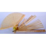 AN EARLY 20TH CENTURY CHINESE CARVED IVORY FAN, together with another fan. Largest 30 cm long. (2)