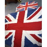 A LARGE UNION FLAG, together with a smaller example. 140 cm x 185 cm.