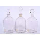 THREE ANTIQUE GLASS DECANTERS, bearing Christies labels to body and etched with foliage. Largest 29