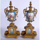 A PAIR OF 19TH CENTURY FRENCH SEVRES PORCELAIN VASES painted with figures within landscapes. 30 cm