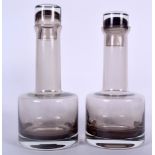 A PAIR OF SCOTTISH CAITHNESS SMOKEY GLASS MORVEN DECANTERS, mallet shaped with shot glass stoppers.