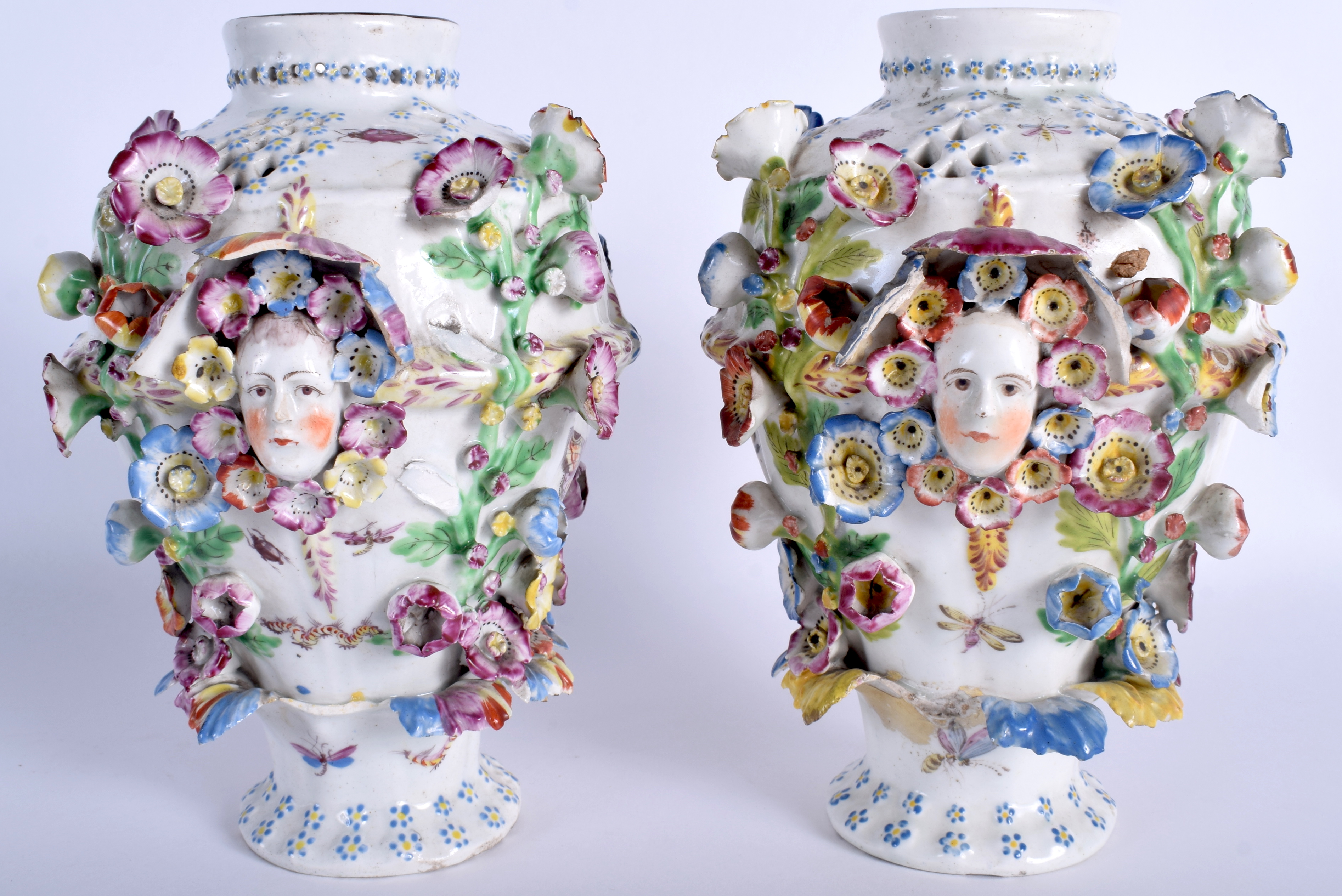 A PAIR OF 18TH CENTURY CHELSEA DERBY PORCELAIN VASES painted with flowers and mask heads. 21 cm hig