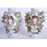 A PAIR OF 18TH CENTURY CHELSEA DERBY PORCELAIN VASES painted with flowers and mask heads. 21 cm hig