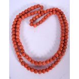 AN EARLY 20TH CENTURY RED CORAL NECKLACE, formed with spherical beads. 92 cm long & weight 120 gram