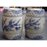 A PAIR OF CHINESE BLUE AND WHITE PORCELAIN GARDEN SEATS, decorated with flowering vines. 46 cm high