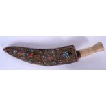 AN UNUSUAL CORAL AND TURQUOISE BEAD INSET NEPALESE KUKRI KNIFE, formed with a bone handle, early 20