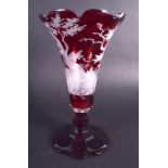 A 19TH CENTURY GERMAN BOHEMIAN RUBY GLASS VASE decorated with stags and landscapes. 19 cm high.