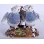 A MID 19TH CENTURY MEISSEN FIGURE OF TWO LOVE BIRDS modelled upon a naturalistic base. 12 cm x 12 c