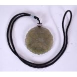 A CHINESE CARVED JADE PENDANT, formed with an agate toggle. 5.25 cm wide.