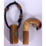 A COW HORN WALKING STICK HANDLE, together with a thick pendant. Handle 10 cm long.