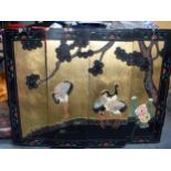 A CHINESE FOUR SECTION LACQUER PANEL OR SCREEN, decorated with cranes in a landscape. 92 cm x 122 c