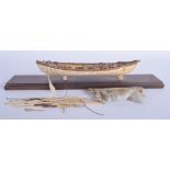 A GOOD 19TH CENTURY CARVED PRISONER OF WAR MODEL OF A WHALING BOAT with carved bone harpoons etc. B