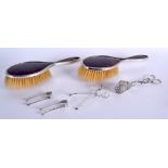 A PAIR OF 1920S SILVER AND TORTOISESHELL BRUSHES together with silver tongs etc. (6)