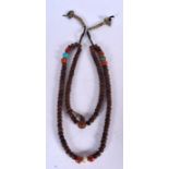 A CHINESE CARVED NUT NECKLACE, formed with coral and turquoise beads. 44 cm long.
