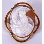 AN ANTIQUE CAMEO BROOCH WITH YELLOW METAL MOUNTS, carved depicting a female seated beside and eagle