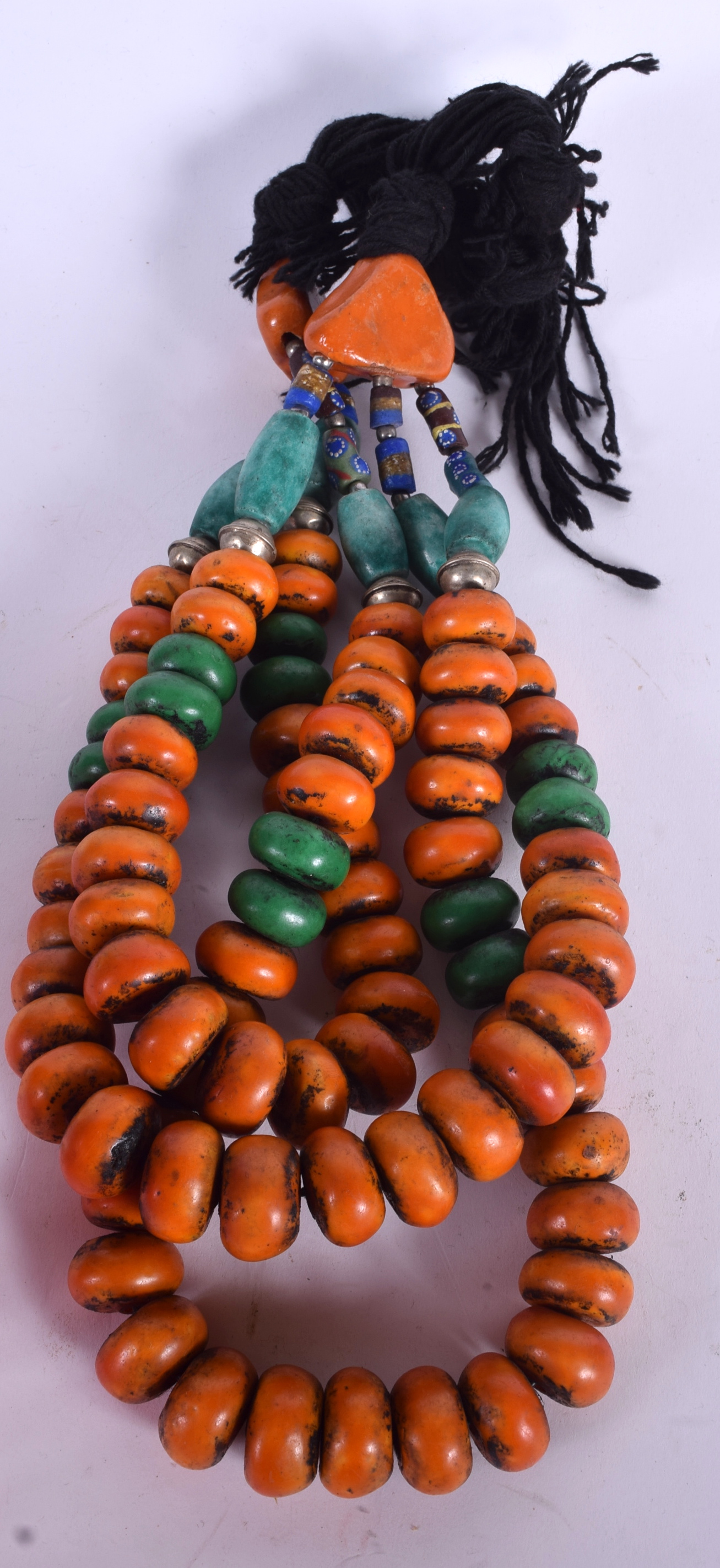 AN EASTERN DOUBLE STAND NECKLACE, formed with amber type and turquoise coloured beads. 98 cm long.