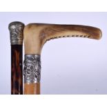 AN EARLY 20TH CENTURY ANTLER HANDLED WALKING STICK, together with a silver top cane. Longest 90 cm.