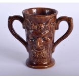 AN EARLY 19TH CENTURY POTTERY TWIN HANDLED BACCHUS LOVING CUP. 10.5 cm high.