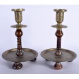 AN UNUSUAL PAIR OF 19TH CENTURY ISLAMIC JADE AND BRASS CANDLESTICKS decorated with Kufic script. 19